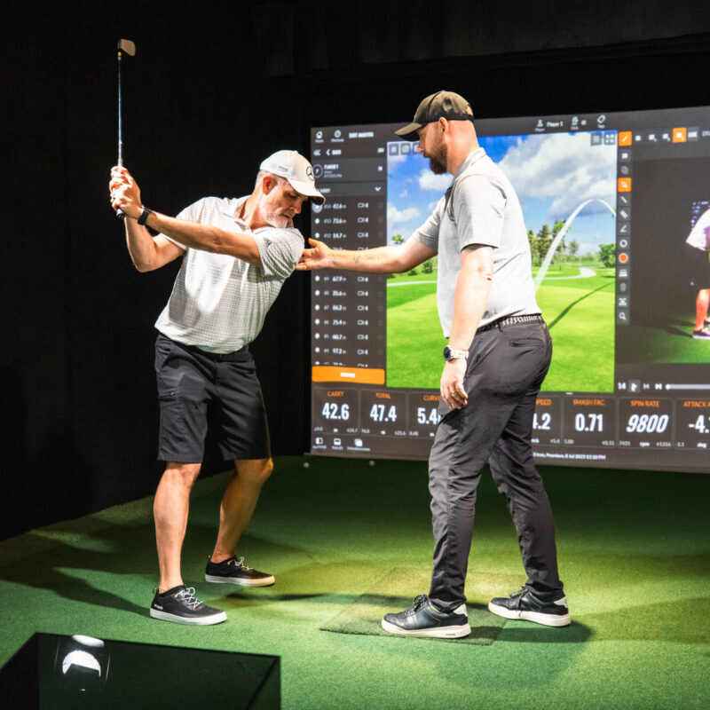 Coach giving a golf lesson